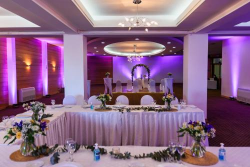 a wedding reception in a purple room with tables and chairs at Hotel Bellavista in Puerto Varas