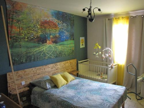 オーベにあるAu Coeur De L Olivetteの壁に絵画が描かれたベッドルーム、ベッド1台が備わります。