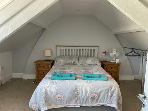 a bedroom with a bed with two towels on it at Braunton Breaks - South Break House in Braunton
