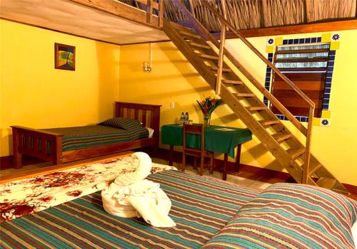 a bedroom with a bunk bed and a staircase at Crystal Paradise Resort in San Ignacio