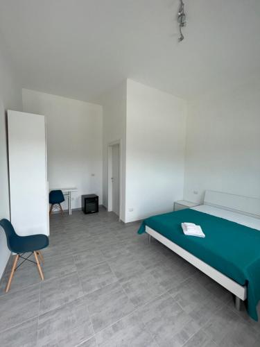 a bedroom with a bed and a chair and a table at Borraco Rooms in San Pietro in Bevagna