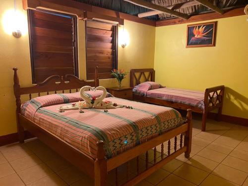 a bedroom with two beds in a room at Crystal Paradise Resort in San Ignacio