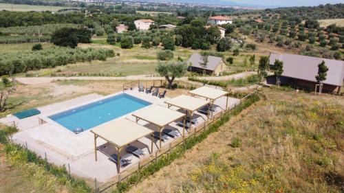 an aerial view of a villa with a swimming pool at Glamping Grancia in Grosseto
