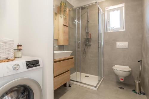 a bathroom with a shower and a toilet and a sink at ABI Attic Apartment in Šibenik