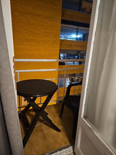 a stool in a room with a table and a chair at Hostal Sol celeste in Lloret de Mar