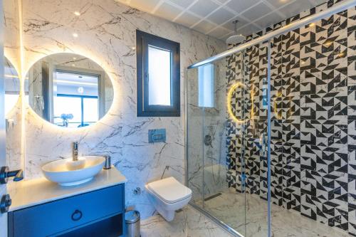 a bathroom with a sink and a shower at Albedo Villa in Kas
