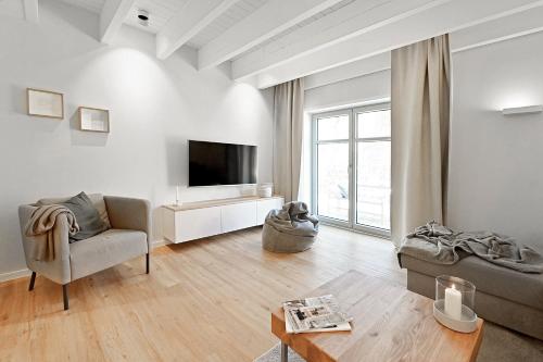 a living room with a couch and a tv at Bi de Bark in Fehmarn
