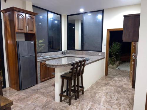 a kitchen with a counter with a sink and a refrigerator at Departamento vista al mar en Puerto López in Puerto López