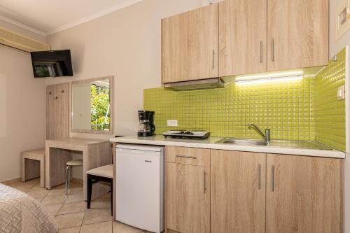 a kitchen with a sink and a counter top at Villa Regina in Keri