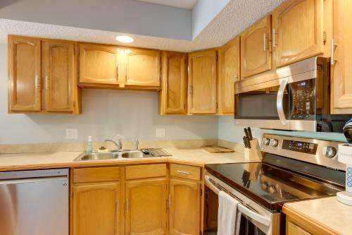 a kitchen with wooden cabinets and a sink at Lakefront Retreat in the Heart of Osage Beach! in Osage Beach