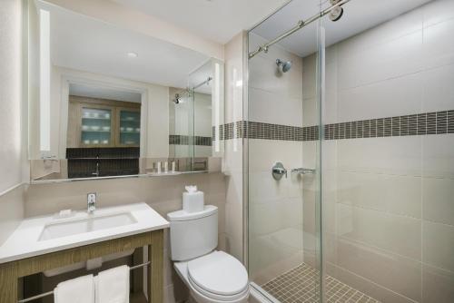 a bathroom with a shower and a toilet and a sink at Residence Inn New York Downtown Manhattan/Financial District in New York