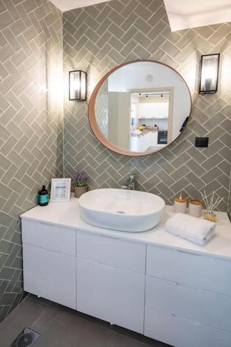a bathroom with a white sink and a mirror at Mi Casa Su Casa in Kos