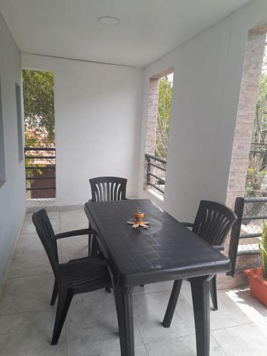 a black table and chairs on a patio at Apartamento Sinde in Villaguay