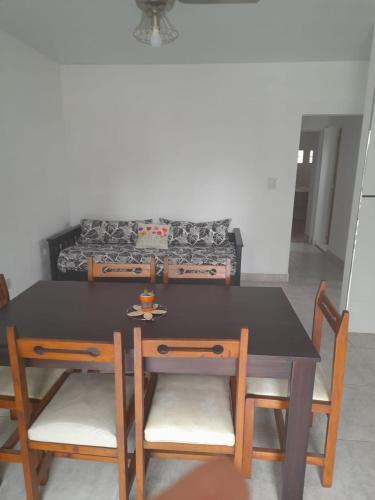 a dining room table and chairs with a couch at Apartamento Sinde in Villaguay