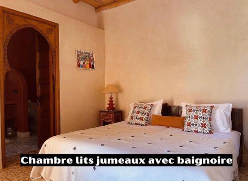 a bedroom with a bed with pillows on it at Villa des Hauts Mogador in Essaouira