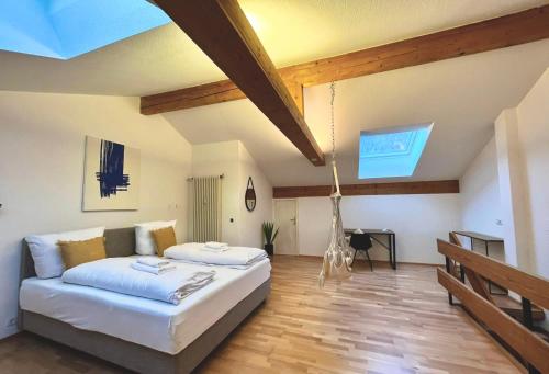 a bedroom with a bed and a desk in a room at Maisonettewohnung Steinbock mit Bergblick in Bayrischzell