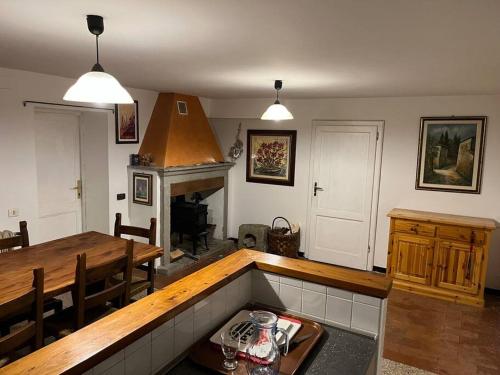 a kitchen with a table and a dining room at Abetone Pian di Novello - trekking hut in Pian di Novello