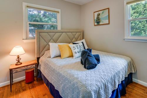 a bedroom with a bed and two windows at Greensboro Vacation Rental 2 Mi to Downtown! in Greensboro