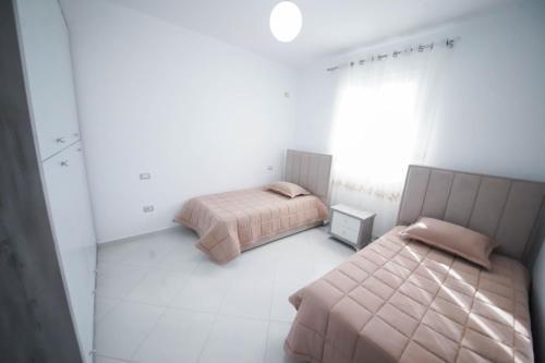 Säng eller sängar i ett rum på Vila Kokoneshi