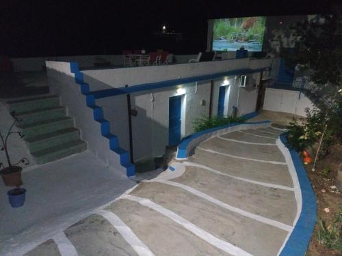 a house with a staircase leading to a building at Villa Kotetsi - Rooms To Let - Volissos - Chios in Volissos