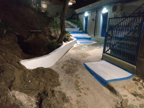 a row of snow mats on a sidewalk next to a building at Villa Kotetsi - Rooms To Let - Volissos - Chios in Volissos