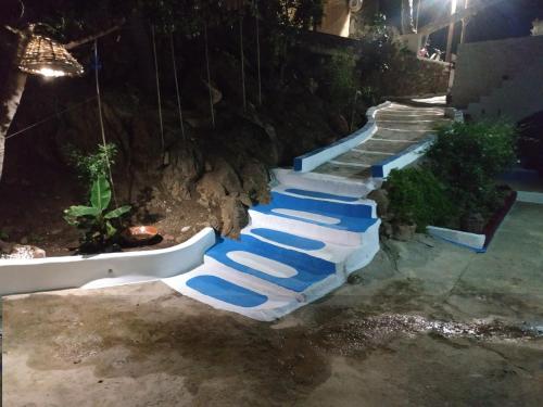 a group of blue lounge chairs sitting on the stairs at Villa Kotetsi - Rooms To Let - Volissos - Chios in Volissos