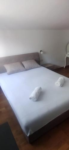 a white bed with two pillows on top of it at Guesthouse Nikoleta 2 in Kotor