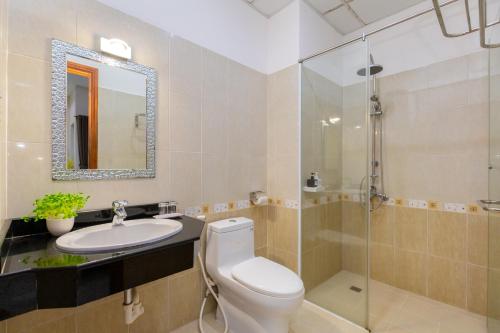 a bathroom with a toilet and a sink and a shower at Queen Garden Hotel & Apartment in Vung Tau