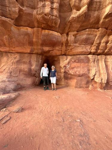 two people standing in a cave in the desert at Yara camp in Wadi Rum