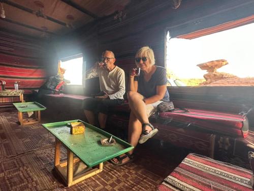 a man and a woman sitting on a couch at Yara camp in Wadi Rum