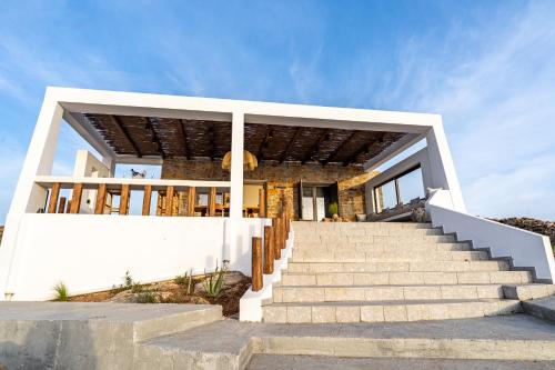 a house on the beach with stairs at Saint Nicholas Resort - Villas in Kithnos