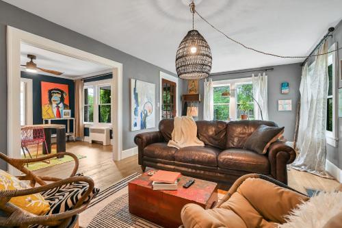 a living room with a brown leather couch at Asheville Urban Farmhouse Entire Home 4 mi to DT in Asheville