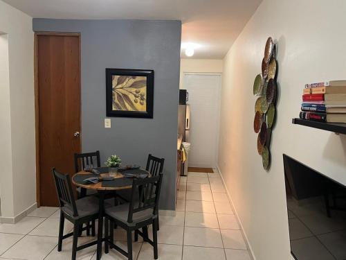 a dining room with a table and chairs at Casa Maria 2BR Apt with terrace in Levittown