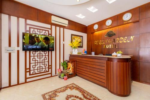 a hotel lobby with a reception desk and a tv at Queen Garden Hotel & Apartment in Vung Tau