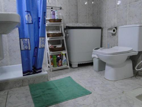 a bathroom with a toilet and a tub and a sink at ( b&b ) Gadara rent room in Um Qeis