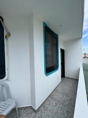 a white wall with a flat screen tv on it at Hostal Brisas Del Mar in Puerto Villamil