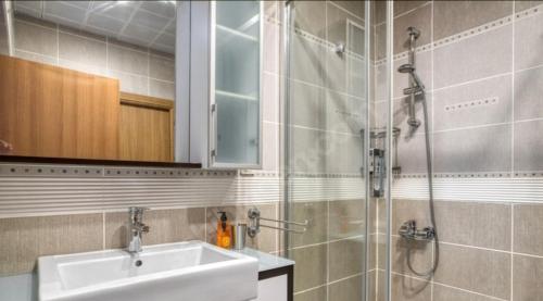 a bathroom with a sink and a shower at Konfor home in Istanbul