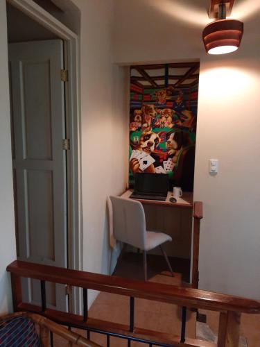 a room with a desk with a laptop on it at Marita's Bed and Breakfast in Nuevo Arenal