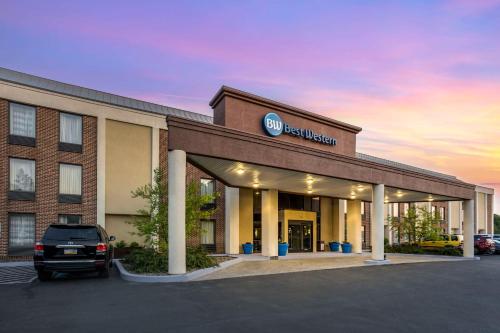a hotel with a car parked in a parking lot at Best Western Harrisburg North Hershey in Harrisburg