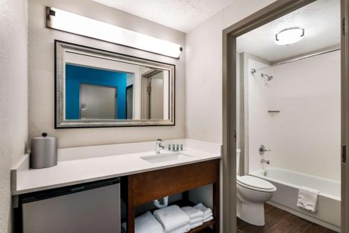 a bathroom with a sink and a toilet at SureStay Plus Hotel by Best Western The Villages in Lady Lake