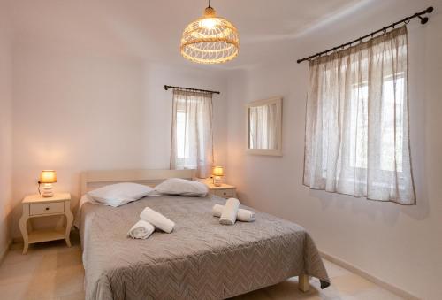 a bedroom with a bed with two towels on it at Villa Anneza Nikola in Angairiá
