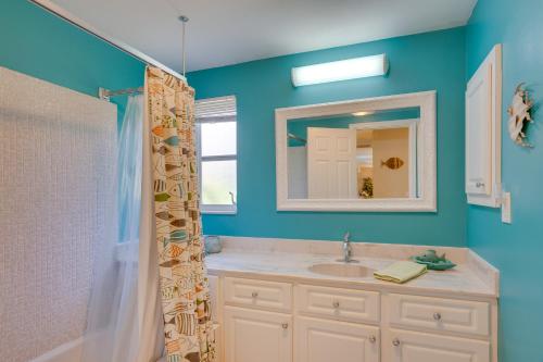 a bathroom with a sink and a mirror at Canalfront Home with Dock and Pool 5 Mi to Ft Myers! in North Fort Myers