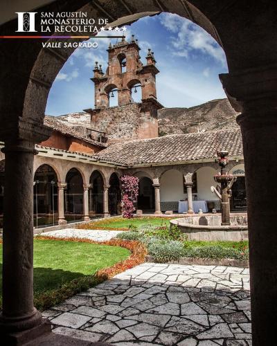 an old building with a tower on top of it at San Agustin Monasterio de la Recoleta in Urubamba