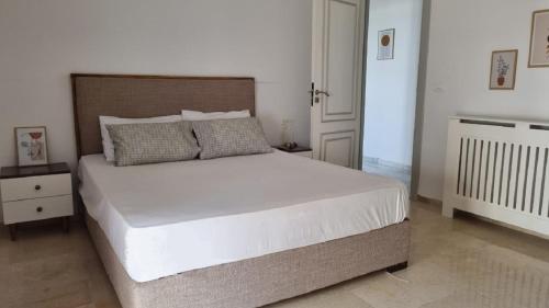 a bedroom with a large white bed in a room at Le 6éme in Sousse