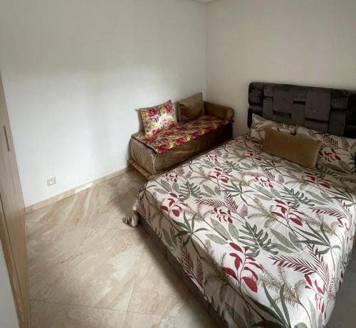 ein Schlafzimmer mit einem Bett und einem Sofa in der Unterkunft Les jardins de Bouznika in Bouznika