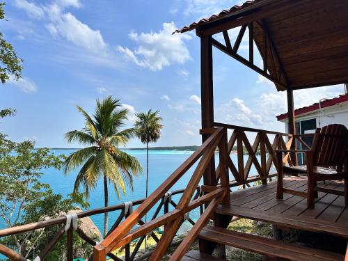 a porch of a house with a view of the ocean at bacalar My Love Front Laguna in Bacalar