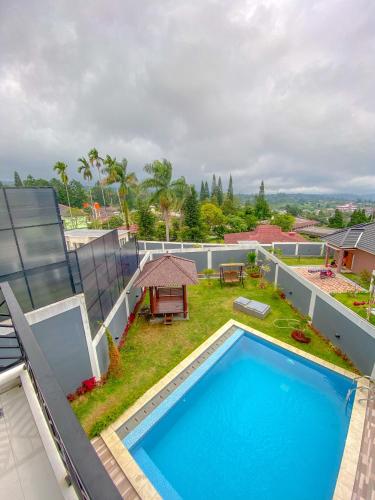 an image of a swimming pool on the roof of a house at Marseillia Hills in Puncak