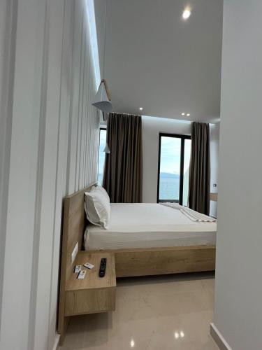 a small bedroom with a bed and a window at Villa Xhefri 2 in Sarandë