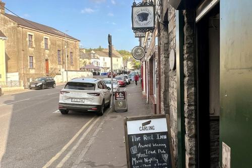 a street with a sign on the side of a building at In the country yet close to town in Carterʼs Bridge