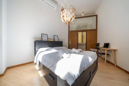 a bedroom with a large bed and a mirror at [Duomo] Delizioso appartamento nel cuore di Modena in Modena